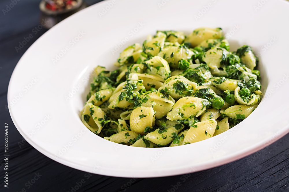 Conchiglie pasta with spinach and green pea pesto. Italian Cuisine. Vegan food. Conchiglie pasta with spinach and green pea pesto. Italian Cuisine. Vegan food.