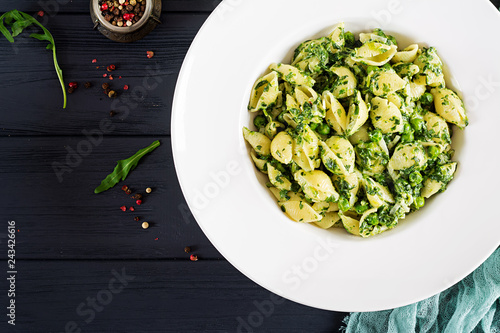 Conchiglie pasta with spinach and green pea pesto. Italian Cuisine. Vegan food. Top view