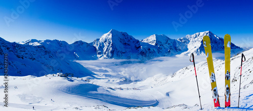 Obraz na płótnie Ski in winter season, mountains and ski touring backcountry equipments on the top of snowy mountains in sunny day. South Tirol, Solda in Italy. w salonie