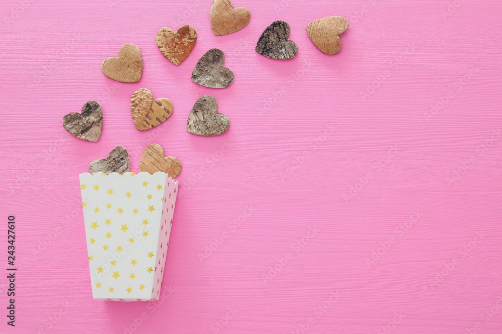 Valentine's day concept. wooden hearts over pink background. Flat lay.