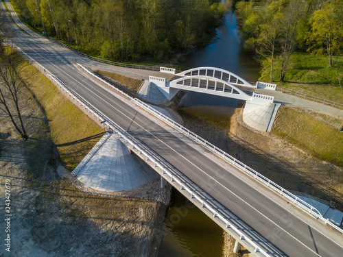 Pedistrian and auto bridge throught the river Vircava in Mezciems, Jelgava. Latvia.  photo