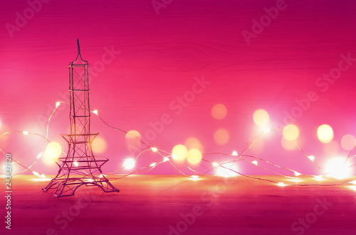 Valentine s day background. Eiffel tower over wooden table and purple background.