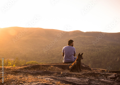 Man with dog at sunset