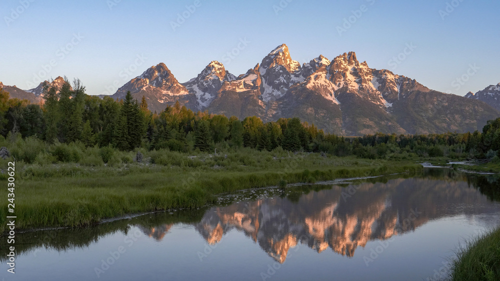 a sunrise shot of grand teton and a stream at schwabacher landing in grand teton national park in the united states