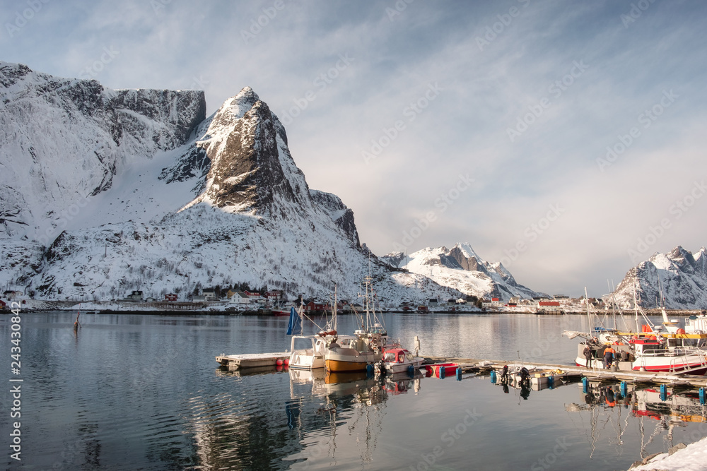 Fishing boat at harbour with snowy mountain