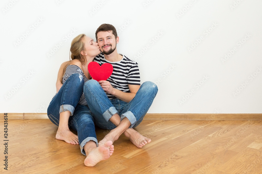 Happy young couple in love is sitting on the floor. Happy young couple in love is sitting on the floor.