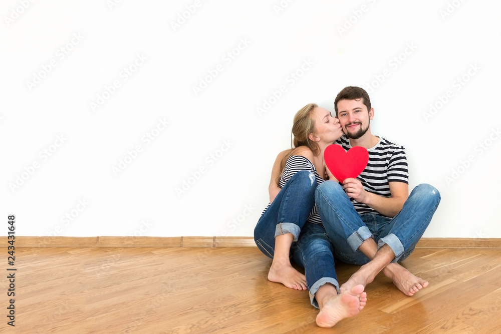 Happy young couple in love is sitting on the floor. Happy young couple in love is sitting on the floor.