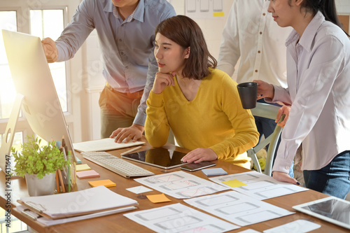 UI creative designer team sketching wireframe layout design for responsive mobile phone application photo