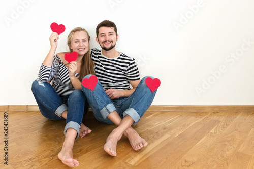 Young man is kissing girl on her cheek. Valentines day.