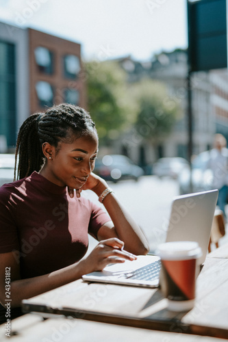 Woman working remotely from a cafe