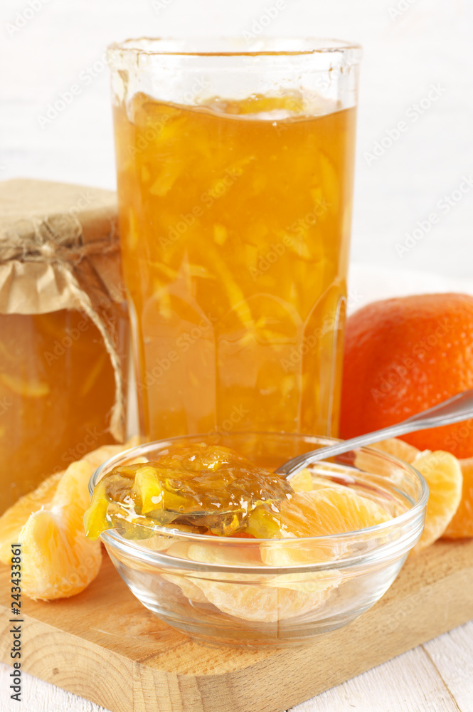 Citrus jam in glass jars and orange slices Citrus jam in glass jars and orange slices