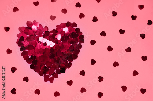 Heart of sequins on a pink background. 14 February