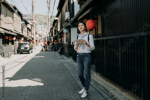 girl visiting Hanamikoji street holding paper map