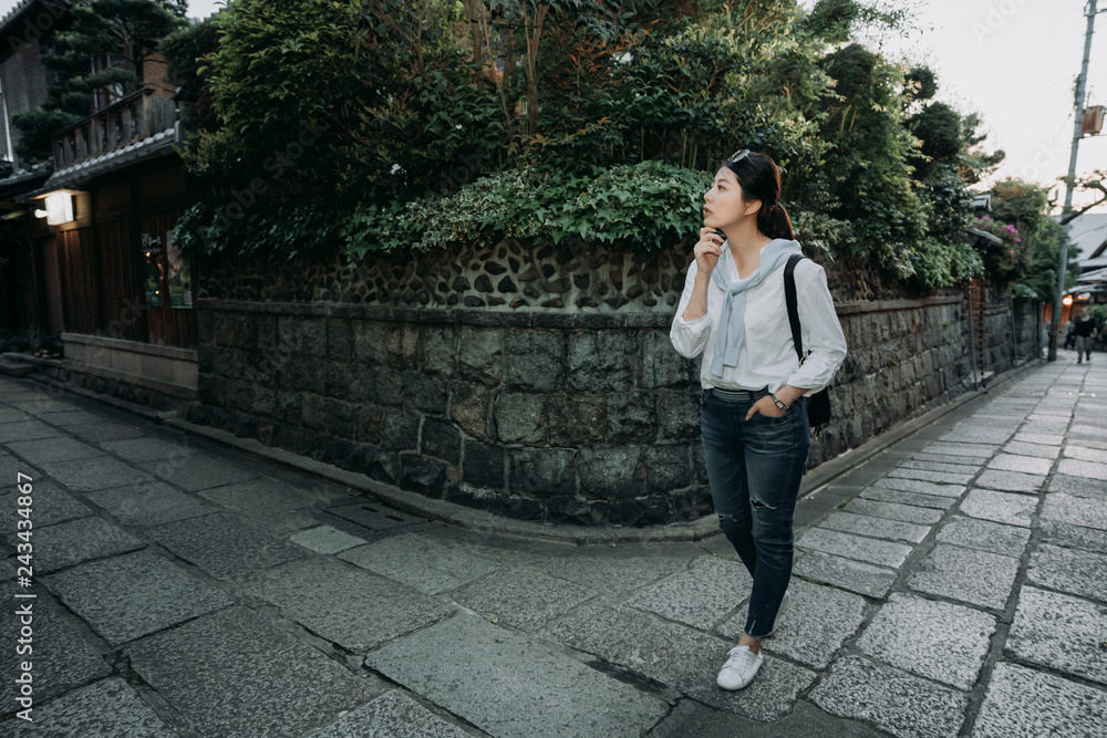 girl tourist thinking the right way back to hotel standing in the corner of crossroad. full length of asian woman walking hand in chin thought of the right road after enjoy sunset in kyoto japan. girl tourist thinking the right way back to hotel standing in the corner of crossroad. full length of asian woman walking hand in chin thought of the right road after enjoy sunset in kyoto japan.
