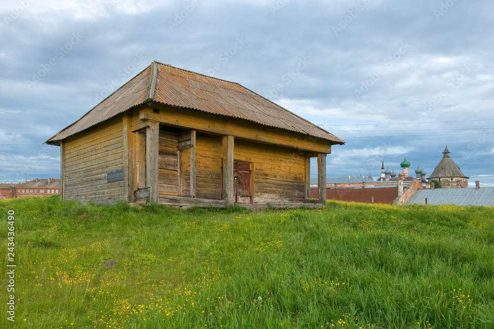 Wooden barn on a green hill