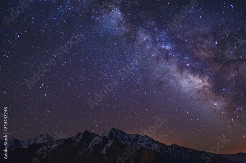 Stars and Milky Way in the clear night sky over Main Caucasian Ridge. Mountain landscape and starry sky background. View from Republic of North Ossetia – Alania, Russia