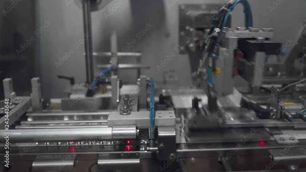Chocolate factory, chocolate candies packaging process, view of factory machine, production of sweets and desserts, chocolates on conveyor. Chocolate factory, chocolate candies packaging process, view of factory machine, production of sweets and desserts, chocolates on conveyor.