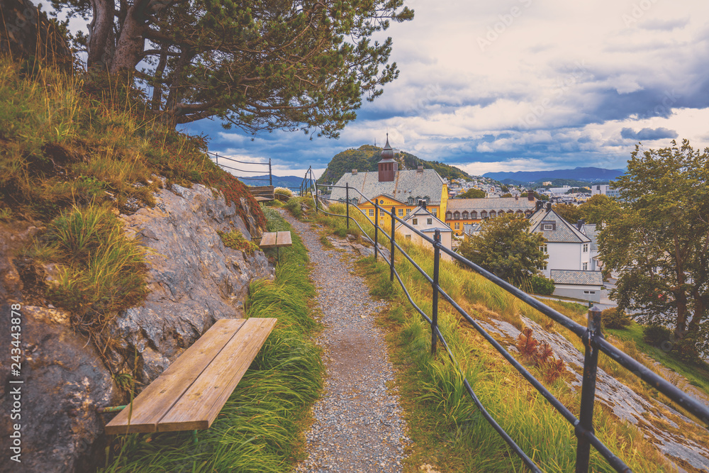 Footpath in the park on the mountain. View of the city of Alesund, Norway, Europe