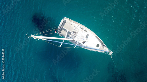 Aerial drone birds eye view of sail boat cruising in the deep blue Aegean sea, Greece