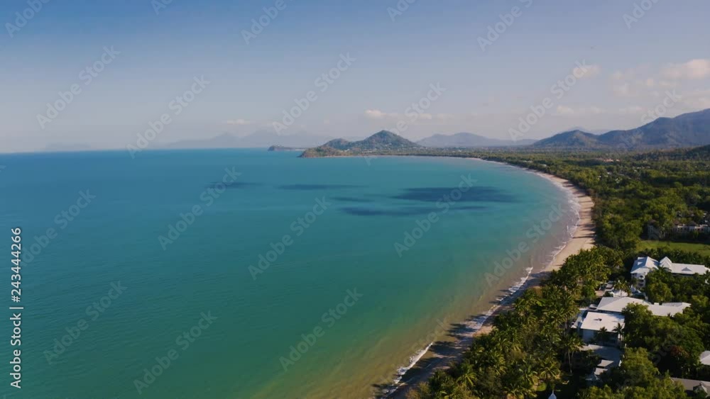 Aerial view on Palm Cove, suburbean town situated on the ocean side with tropical vegetation in Cairns, Queensland, Australia Aerial view on Palm Cove, suburbean town situated on the ocean side with tropical vegetation in Cairns, Queensland, Australia