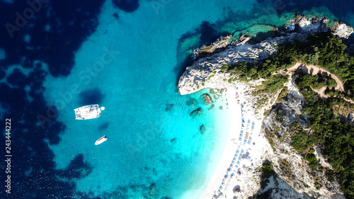 Aerial drone bird s eye view photo of sail boats docked in tropical caribbean paradise bay with white rock caves and turquoise clear sea