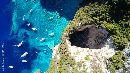 Fototapeta Naklejka Na Ścianę i Meble -  Aerial drone bird's eye view photo of sail boats docked in tropical caribbean paradise bay with white rock caves and turquoise clear sea