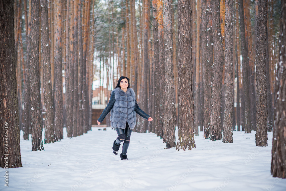 Hispanic happy woman jumping and having fun outdoor. Good mood, winter nice time 