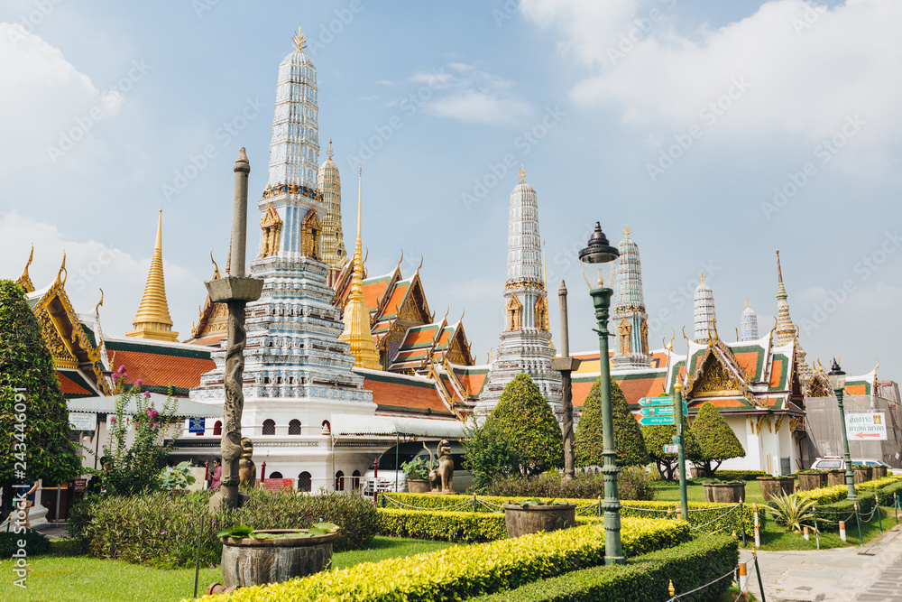 The beauty of the Emerald Buddha Temple . And while the gold of the temple catching the light. This is an important buddhist temple of thailand and a famous tourist destination.
