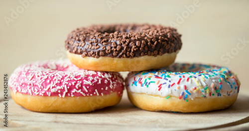 Web banner of sweet colourful donut cakes - junk food concept