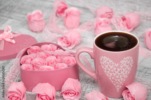 Pink porcelain coffee cup and pink heart roses