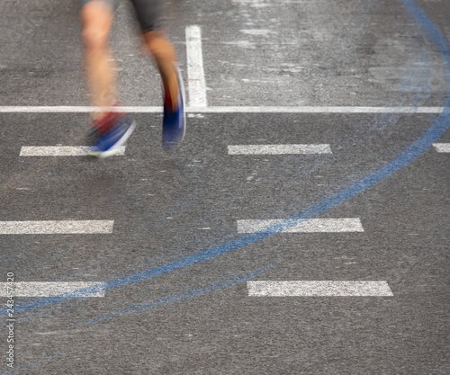 Runner legs blurred motion following blue line