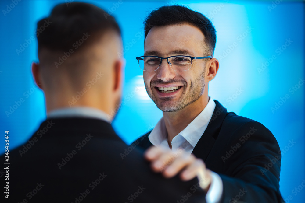 The smiling men pat on the shoulder in the office Stock Photo Adobe Stock