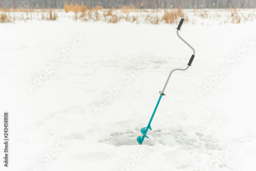 drill the hole on the ice in winter 