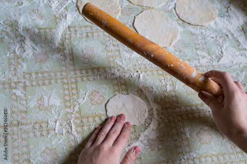 Female hands of a cook close up, knead dough, cook dough