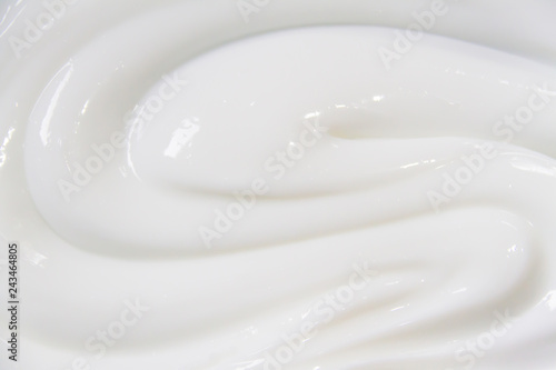 The white surface of the cream lotion softens the background. photo