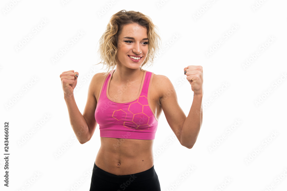 Portrait of beautiful young fit girl showing fists like winning Portrait of beautiful young fit girl showing fists like winning