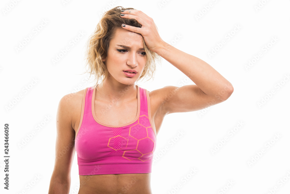 Portrait of beautiful young fit girl holding head like hurting Portrait of beautiful young fit girl holding head like hurting