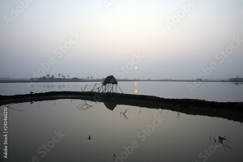 A stunning sunrise looking over the holiest of rivers in India. Ganges delta in Sundarbans, West Bengal, India. photo