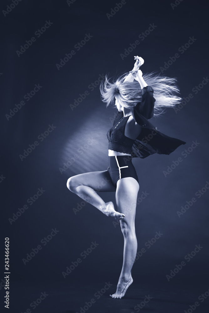 Beautiful gymnast athlete teenage girl wearing dancer colorful leotard working out, dancing, posing, sitting in splits, doing backbend art gymnastics exercise, studio, dark background Beautiful gymnast athlete teenage girl wearing dancer colorful leotard working out, dancing, posing, sitting in splits, doing backbend art gymnastics exercise, studio, dark background