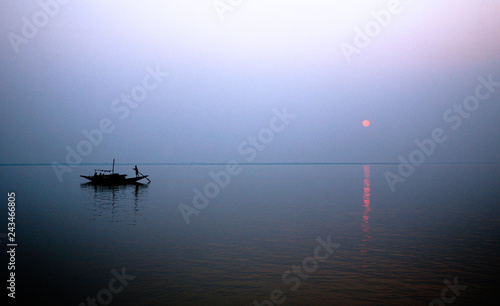 A stunning sunset looking over the holiest of rivers in India. Ganges delta in Sundarbans, West Bengal, India