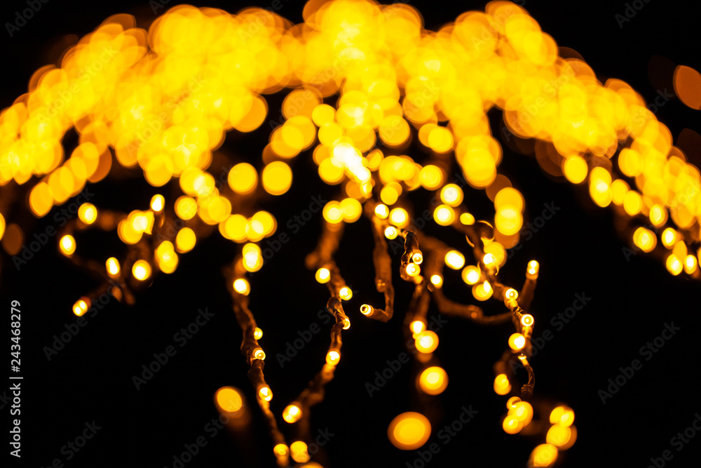 bright yellow blurry lights of a garland, background - obrazy, fototapety, plakaty 