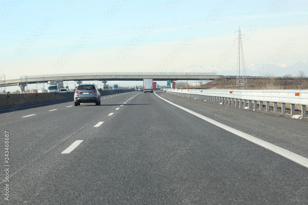 Naklejka premium lanes with cars and trucks on italian highway