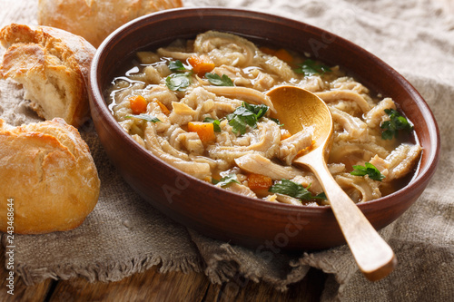 Flaki or flaczki is a traditional Polish meat stew close-up in a bowl served with bread. horizontal photo