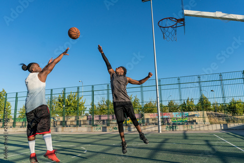 two young people enjoying basketball © stockmanushots
