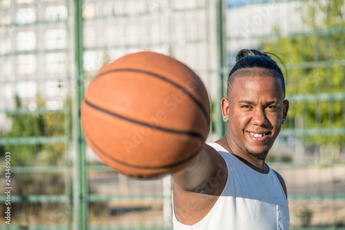 Young afroamerican man enjoying basketball