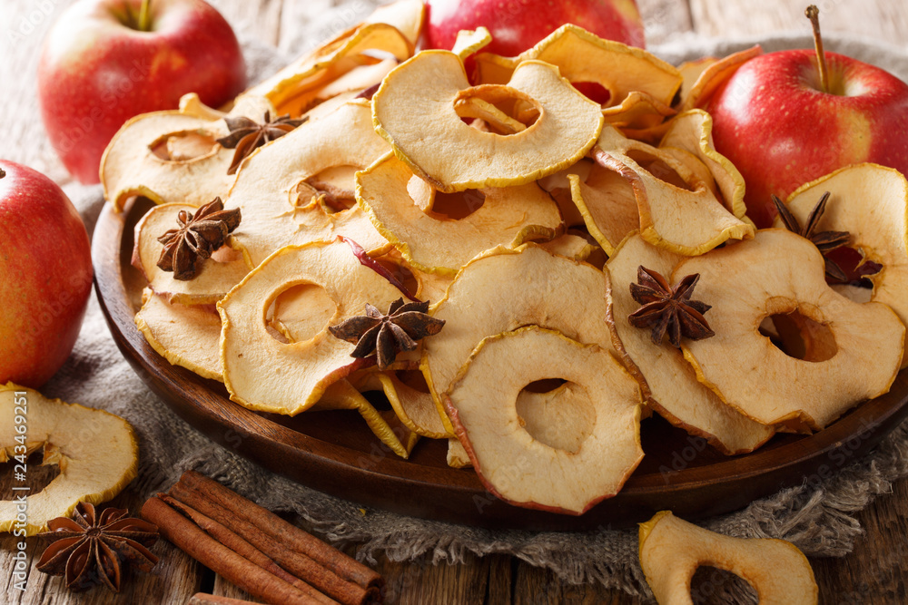 Fototapeta premium Crispy apple chips made from fresh fruit close-up on a plate. horizontal