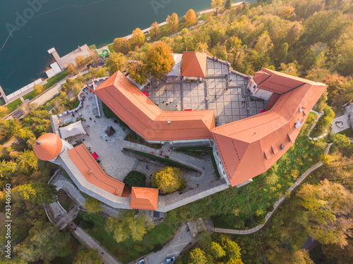 Top down aerial view of medieval castle by the lake Bled in Slovenia. Beautiful nature of Slovenia in fall. photo