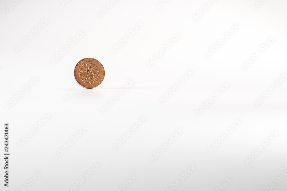 1 British pound coin falling on white background, isolated 1 British pound coin falling on white background, isolated