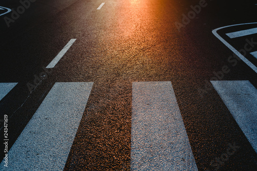 Фотография Lonely street with pedestrian crossing at sunset, texture with space for text