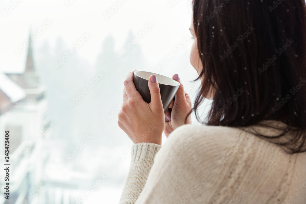 Woman with cup of coffee in winter morning. at the hotel or spa Woman with cup of coffee in winter morning. at the hotel or spa